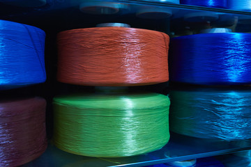 Large multi colored coils with synthetic packaging twine. Background