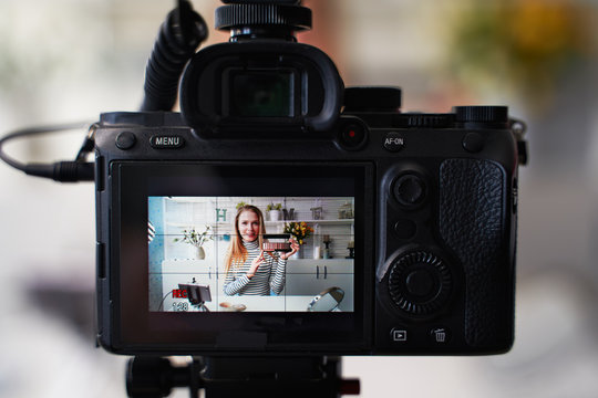 Display of camera recording video blog for blonde beauty blogger woman with make-up at home studio. Influencer vlogger girl live streaming cosmetics masterclass. Online learning and marketing concept.