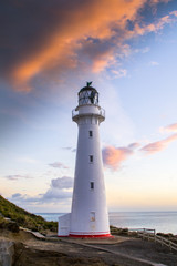 Panoramic scenic landscape view of the Castlepoint lighthouse in sunrise colours, white landmark, tourist popular attraction/destination in North Island, New Zealand.  © Dajahof