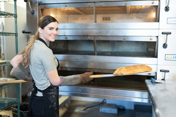 Young woman baking some bread