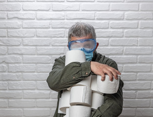 Man with many rolls of toilet paper during quarantine. Hamster purchase.