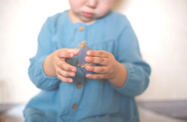 Fototapeta premium blue-eyed blonde girl with a basket of Easter eggs in a vintage dress