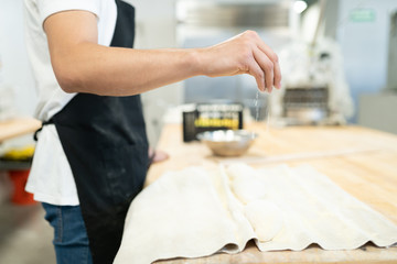 Using some flour in a bakery