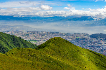 Aerial view from the cityscape of Quito city skyscrapers seen from the Pichincha Volcano, Ecuador.