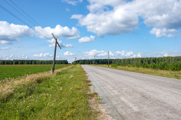 Fototapeta na wymiar electric poles in emergency condition standing along the road