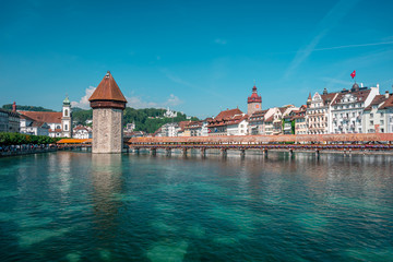 Famous Chapel Bridge, the city's symbol and one of the Switzerland's main tourist attractions on sunny summer day, Switzerland. Historic city center of Lucerne