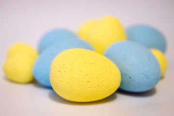 Multi-colored eggs made of polystyrene, Easter decor for studios made of polystyrene foam on a white background