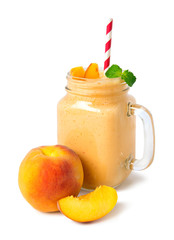 Smoothie of fresh peach, yogurt decorated with mint leaves isolated on a white background