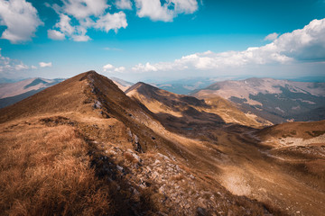 Hiking trough epic mountain landscape with a big backpack, exploring and feeling the freedom of nature