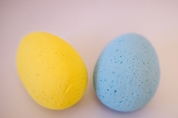 Multi-colored eggs made of polystyrene, Easter decor for studios made of polystyrene foam on a white background