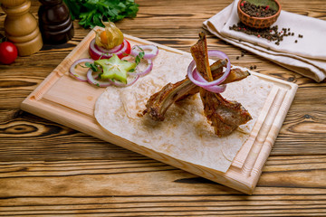 Rack of lamb on wooden table