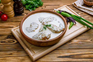 chicken chkmeruli in Georgian on wooden table