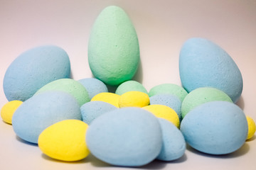 Multi-colored eggs made of polystyrene, Easter decor for studios made of polystyrene foam on a white background