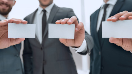 three business partners showing their business card form