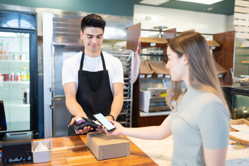 Woman paying with her smartphone