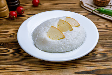 mamaliga with cheese on wooden table, Georgian cuisine