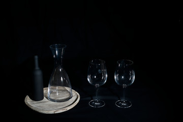 Wine glasses with bottle and pourer.