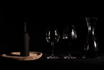Wine glasses with bottle and pourer.