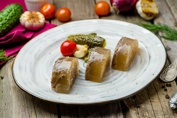 jelly with beef in a plate on wooden table