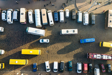 Aerial view of many cars and buses moving on a busy city street.