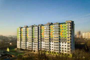 Aerial view of a tall residential apartment building with many windows and balconies.