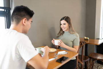 Fototapeta premium Happy couple enjoying coffee together