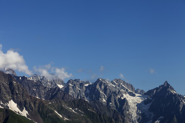 Sunlit high mountains with snow and glacier