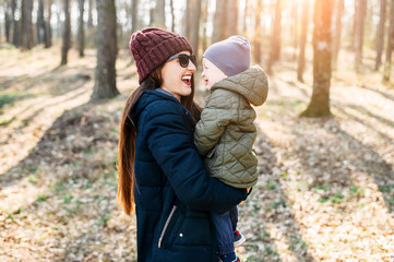 Mother and baby son spend time outdoors together