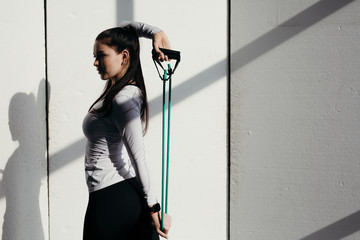The coach stretches the muscles of the back using the green expander. White background with bright...