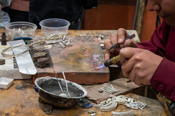Indigenous jeweler working - obrazy, fototapety, plakaty