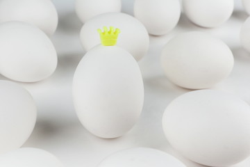 egg on a white background with a crown. concept of individuality