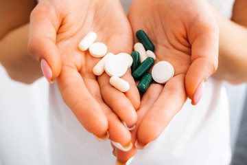 Pills in the hands close-up. Antibiotics. Antidepressants. Vitamin tablets. Antiviral. The treatment of diarrhea. The medicine is in capsules. Narcotic drug.