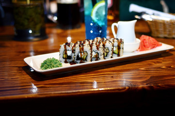Tasty and fresh sushi on a white plate in a cafe