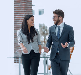 employees of the company discuss working issues standing in the office