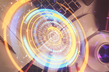 Technology hologram drawing over computer on the desktop background. Top view. Double exposure. Tech concept.