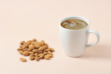 Cappuccino with almond milk milk foam. The concept of products for a healthy diet. An alternative to cow's milk. Light background Close-up. Free space for text.