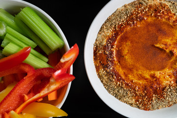Healthy Green food served on a dark table. Health and clean eating. Hummus with oil in a shape of a heart.