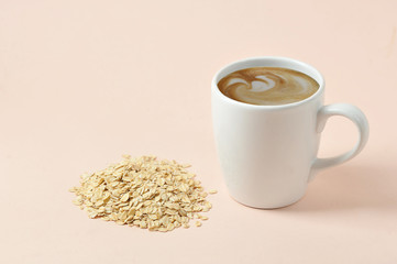 Cappuccino with oatmeal milk foam. The concept of products for a healthy diet. An alternative to cow's milk. Light background Close-up. Free space for text.
