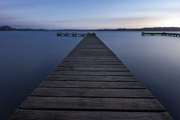 Fototapeta na wymiar Pier on Lake Calm, Relaxing Sunrise Views