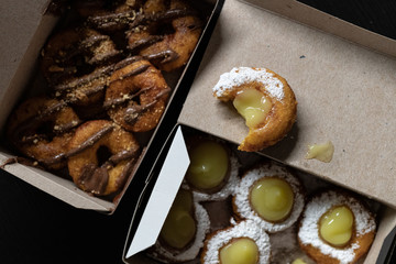 Mini doughnuts with custard and chocolate sauce and nuts