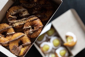 Mini doughnuts with custard and chocolate sauce and nuts