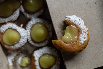 Mini doughnuts with custard and chocolate sauce and nuts