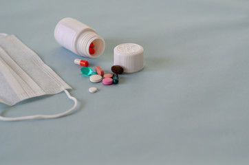 Assorted pharmaceutical medicine pills, tablets and capsules over blue background