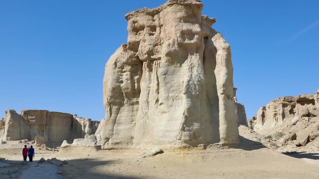 Right to left pan people visiting the Valley of the Stars in Qeshm southern Iran with strange rock formations