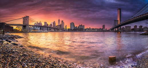 New york skyline reflection on the Hudson river at Brooklyn bridge and Manhattan Bridge at sunset...