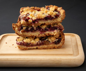 plum pie crumble on a brown wooden cutting board