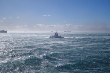 Tug during bad weather at sea / storm