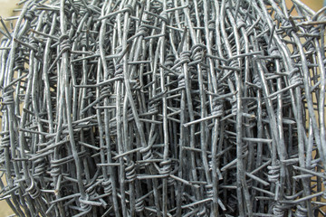 A roll of barbed wire .background of a barbed roll