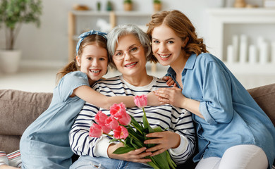 Happy senior woman with daughter and granddaughter.