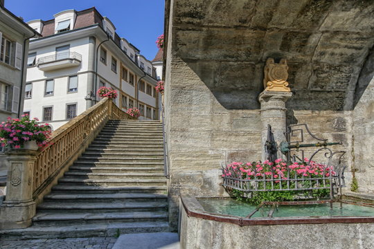 Fountain of Saint-Laurent collegiate church in Estavayer-le-lac by day, Fribourg, Switzerland
